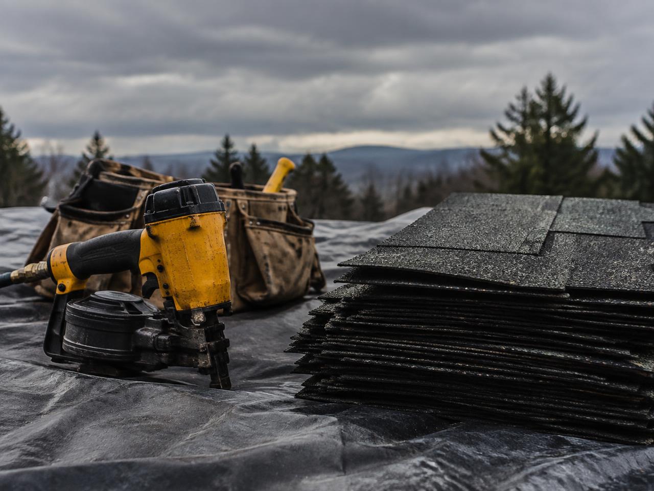 Roofing tools and materials prepared on a roof